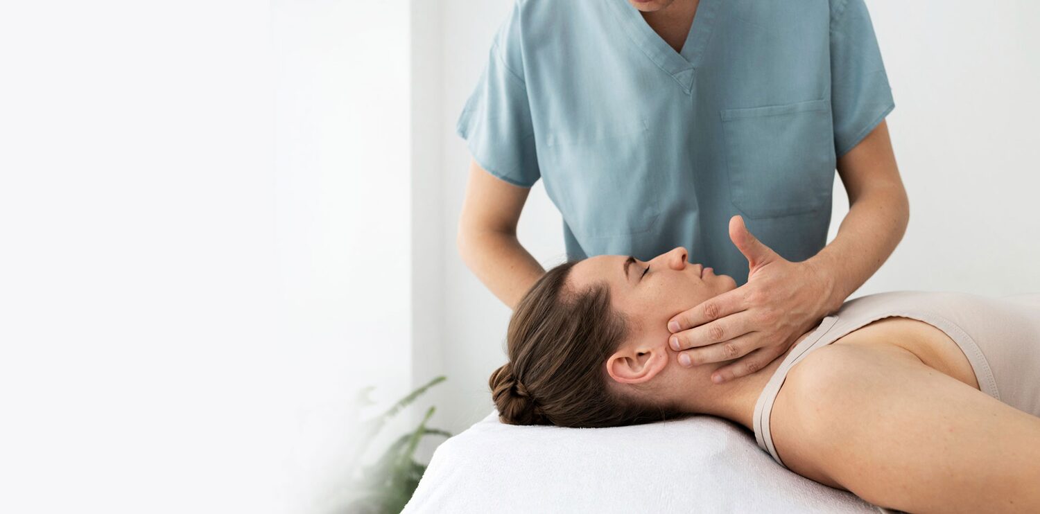 Specialist clinician assessing a patient's jaw and temporomandibular joint